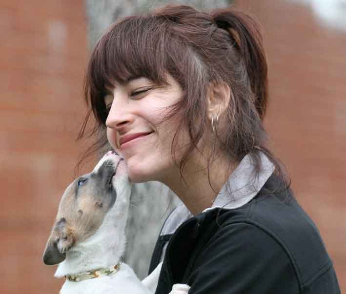 Debbie getting a kiss from young puppy Crime.
